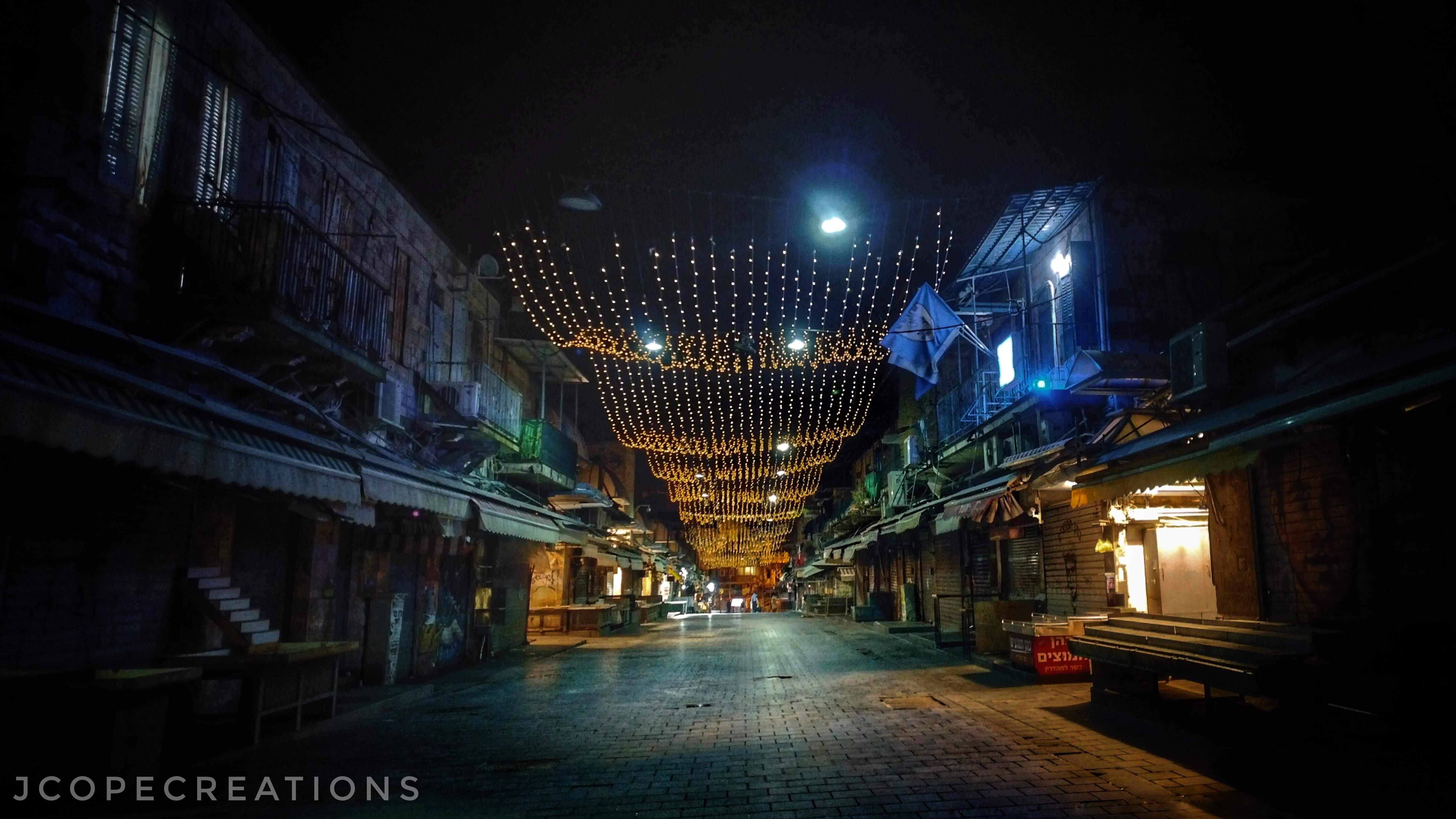 A market lit up at night, empty